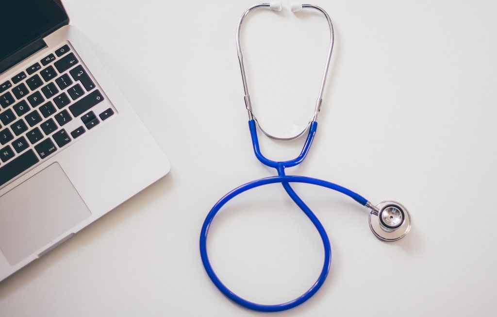 stethoscope next to computer