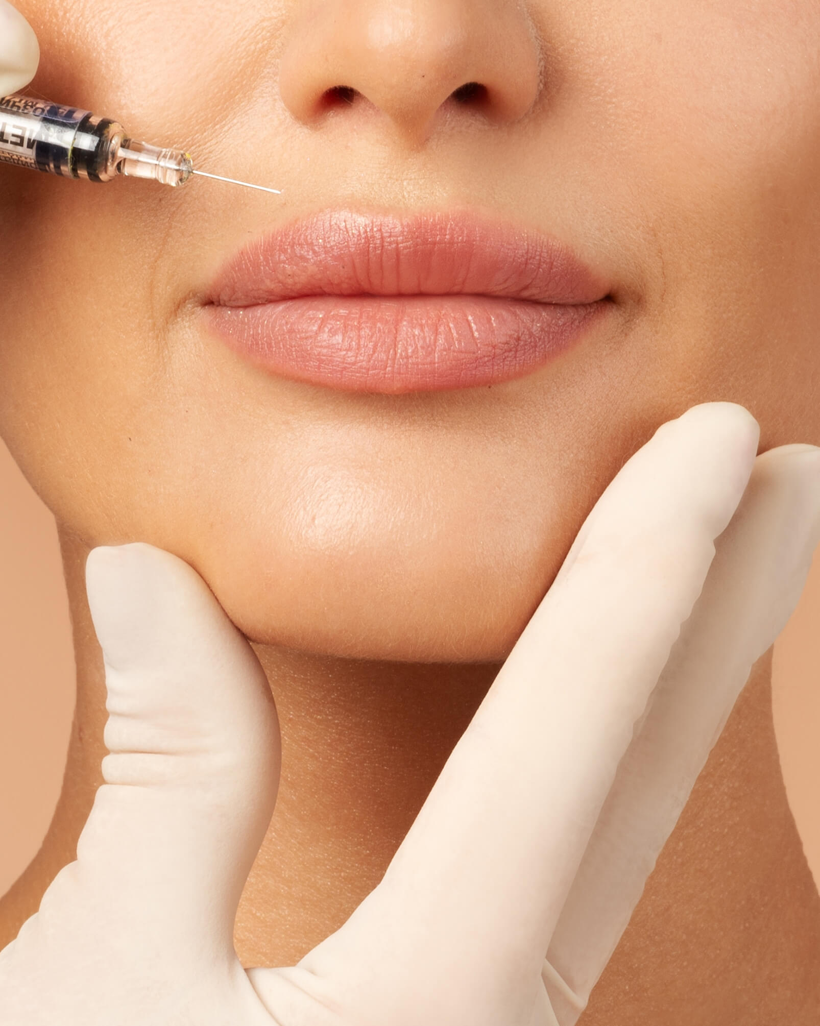 Young lady getting beauty injection in her lips