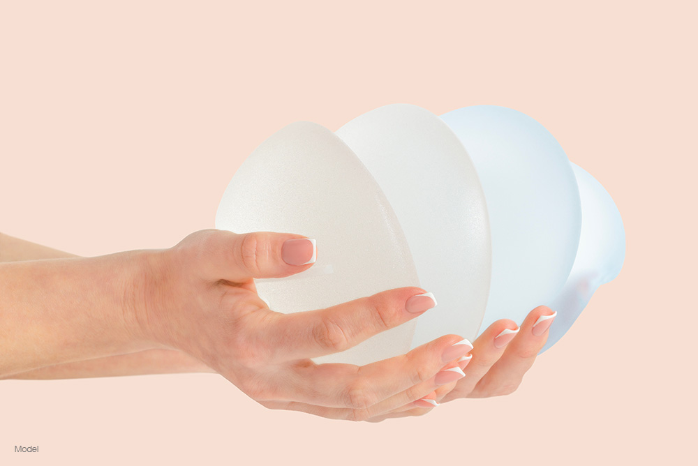 person holding implants